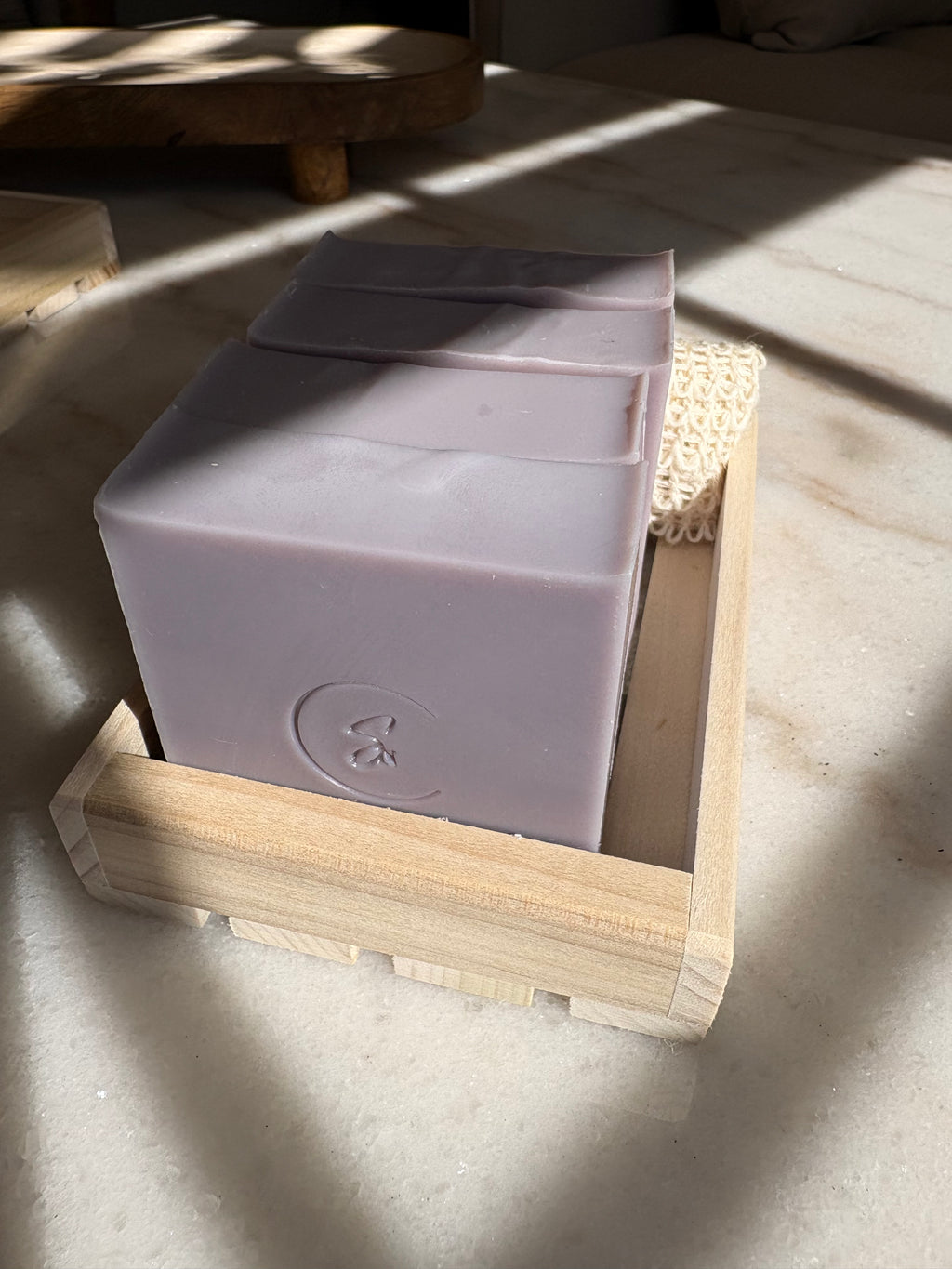 Artisan Gromwell beauty bar in a wooden holder on a light surface