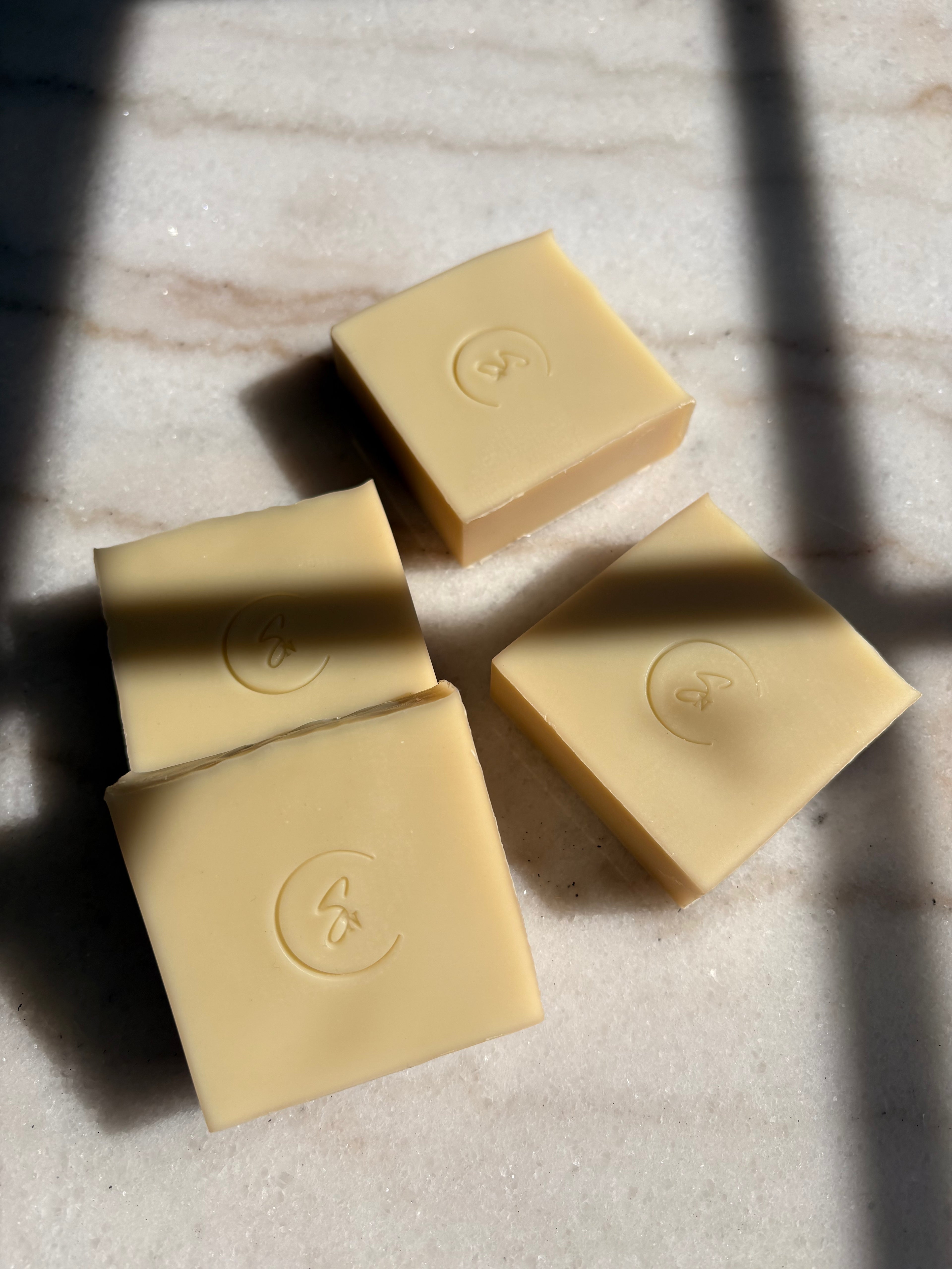 Gentle chamomile soap bar styled in minimalist natural setting