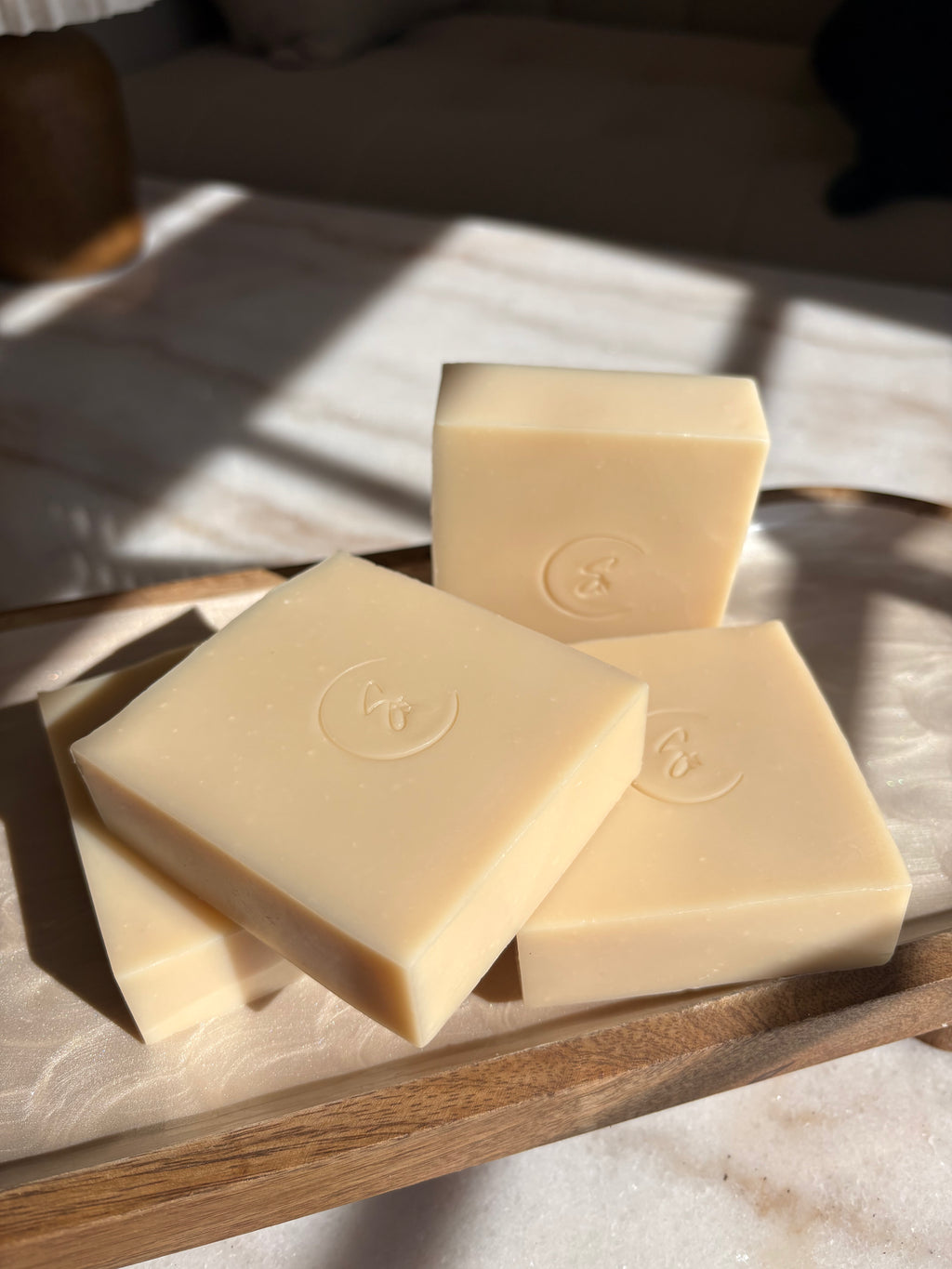 Handcrafted fermented rice soap displayed with rice and delicate botanical accents.